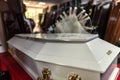 Wooden coffin covered with white acrylic in the funeral parlor