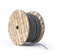 Wooden coil with cable on a white background. Royalty Free Stock Photo