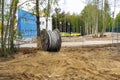 wooden coil with an electric cable is lying on a construction site Royalty Free Stock Photo