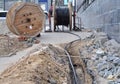 Wooden coil of electric cable and optical fibres in the digging trench on the construction site Royalty Free Stock Photo