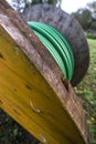 Wooden coil of wet green Electric Cable outdoor Royalty Free Stock Photo