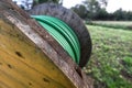 Wooden coil of wet green Electric Cable outdoor Royalty Free Stock Photo