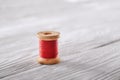 Coil with red reel on white wooden background Royalty Free Stock Photo