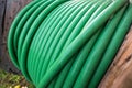 Wooden coil of wet green Electric Cable outdoor Royalty Free Stock Photo