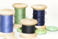 Wooden coils with blue and green threads and buttons Royalty Free Stock Photo