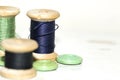 Wooden coils with blue and green threads close-up Royalty Free Stock Photo