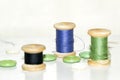 wooden coils with blue and green threads and lots of green butto Royalty Free Stock Photo