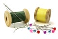 Wooden coils with threads, pins and needle for sewing on a white background Royalty Free Stock Photo