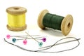 Wooden coils with threads, pins and needle for sewing on a white background Royalty Free Stock Photo