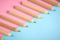 Wooden color pencils on blue background, flat lay