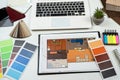 wooden color samples and blueprints of project with laptop for interior renovation in workplace Royalty Free Stock Photo