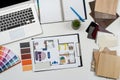 wooden color samples and blueprints of project with laptop for interior renovation in workplace Royalty Free Stock Photo