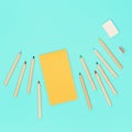 Wooden colored pencils and yellow sketch pad for drawing. Workplace of artist. Royalty Free Stock Photo
