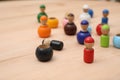 Wooden colorful dolls shaped building blocks on table, closeup. Montessori toy