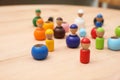 Wooden colorful dolls shaped building blocks on table, closeup. Montessori toy