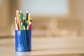 Wooden colorful drawing pencils arranged in plastic jug on light copy space background Royalty Free Stock Photo