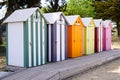 Wooden colourful beach huts with front panel girl name text Royalty Free Stock Photo