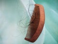 Wooden comb brush with lost hair in the bathroom Royalty Free Stock Photo