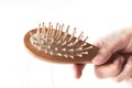 Wooden comb brush with lost hair Royalty Free Stock Photo