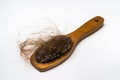 Wooden comb brush with lost hair Royalty Free Stock Photo