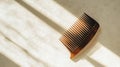 Wooden comb resting on a soft surface with dramatic shadows during early morning light. Generative AI Royalty Free Stock Photo
