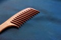 A wooden comb on a nevy blue background Royalty Free Stock Photo