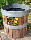 Wooden Compost Bin Full of Kitchen Waste in a Lush Green Garden Setting Royalty Free Stock Photo