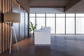 Wooden and concrete office lobby interior with reception desk, panoramic window with city view and other objects. Waiting area and Royalty Free Stock Photo