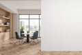 Cozy office meeting room interior with table, shelf and window. Mockup wall Royalty Free Stock Photo