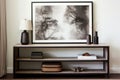 a wooden console table with a large, monochrome print above it