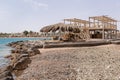 Wooden construction and beach umbrella of palm tree on a deserted , abandoned beach