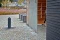 Wooden construction of the bus stop, shelter of a gazebo pergola with a bench and shelves for storing books and magazines. the wal Royalty Free Stock Photo