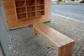Wooden construction of the bus stop, shelter of a gazebo pergola with a bench and shelves for storing books and magazines. the wal Royalty Free Stock Photo