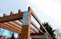 Wooden construction of the bus stop, shelter of a gazebo pergola. the roof and walls are lined with polycarbonate plexiglass glass Royalty Free Stock Photo