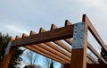 Wooden construction of the bus stop, shelter of a gazebo pergola. the roof and walls are lined with polycarbonate plexiglass glass Royalty Free Stock Photo