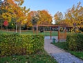 wooden construction of the bus stop, shelter of a gazebo pergola. Royalty Free Stock Photo