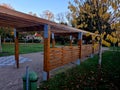 wooden construction of the bus stop, shelter of a gazebo pergola. Royalty Free Stock Photo