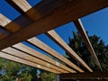 wooden construction of the bus stop, shelter of a gazebo pergola Royalty Free Stock Photo