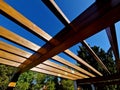 wooden construction of the bus stop, shelter of a gazebo pergola Royalty Free Stock Photo