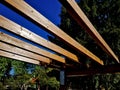 wooden construction of the bus stop, shelter of a gazebo pergola Royalty Free Stock Photo