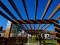 wooden construction of the bus stop, shelter of a gazebo pergola Royalty Free Stock Photo