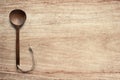 Wooden cooking spoon vertically lying on clean wooden table top view shot,