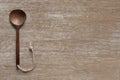 Wooden cooking spoon vertically lying on clean wooden table top view shot