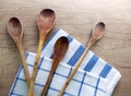 Wooden cooking spoons and cotton dishcloths on the table Royalty Free Stock Photo