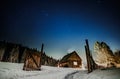 Wooden cottage with blue starry sky at night Royalty Free Stock Photo