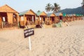 Wooden cottage and cabins of sandy beach resort with sign Dont Disturb Our Guests