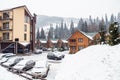 Wooden cottage house in mountain resort. Christmas winter landscape. Beautiful winter cottage covered snow. Royalty Free Stock Photo