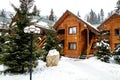 Wooden cottage house in mountain resort. Christmas winter landscape. Beautiful winter cottage covered snow. Royalty Free Stock Photo