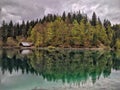 Wooden cottage on mirroring lake reflection in the woods Royalty Free Stock Photo