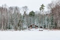 Wooden cottage in snow covered forest in Finland Royalty Free Stock Photo